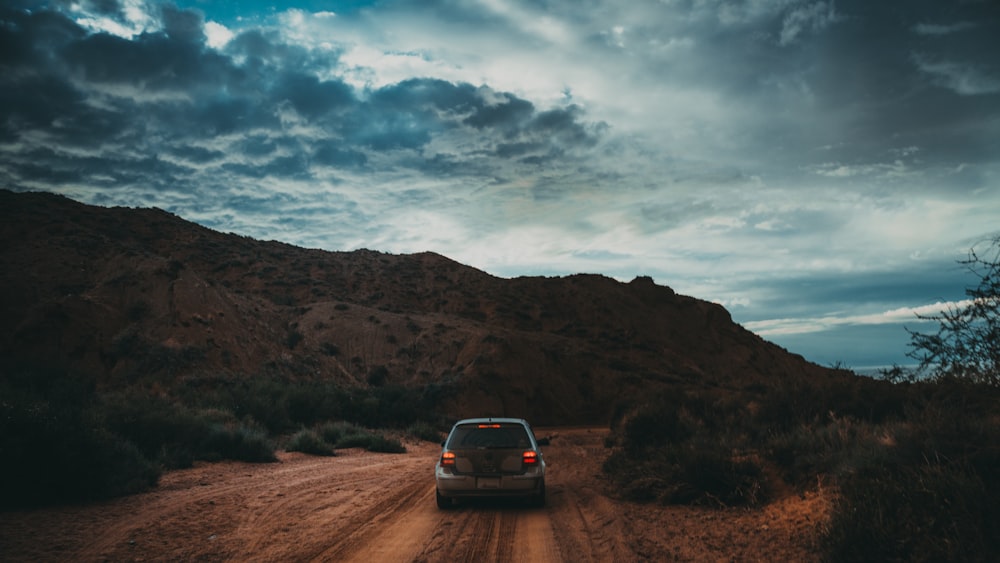 vehicle near brown mountains