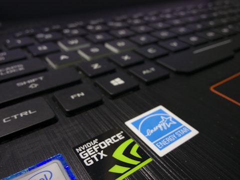Close-up of a laptop keyboard showing several keys including Ctrl, Shift, and Fn. Near the keyboard are stickers such as NVIDIA GeForce GTX and Energy Star, indicating hardware specifications and energy efficiency.