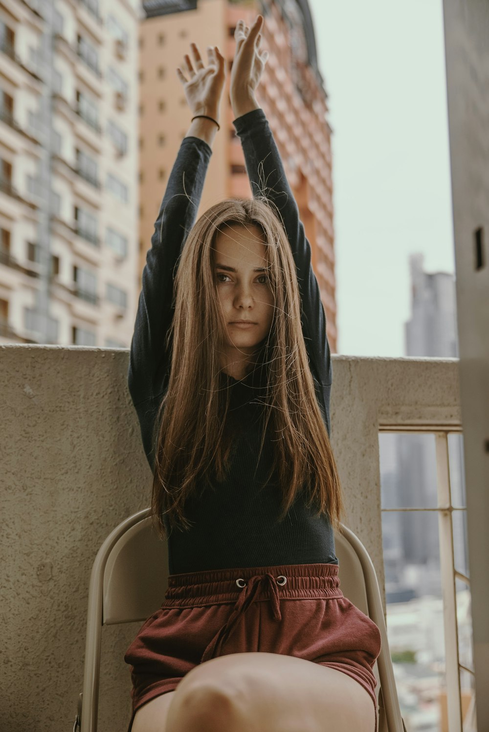 woman raising her hand holding