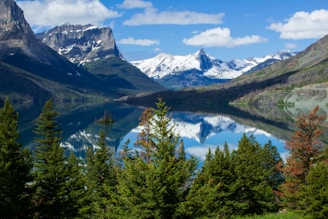 lake surrounded by mountains at daytime