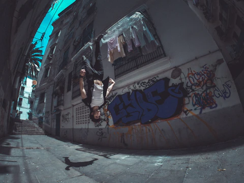 man performing backflip between house