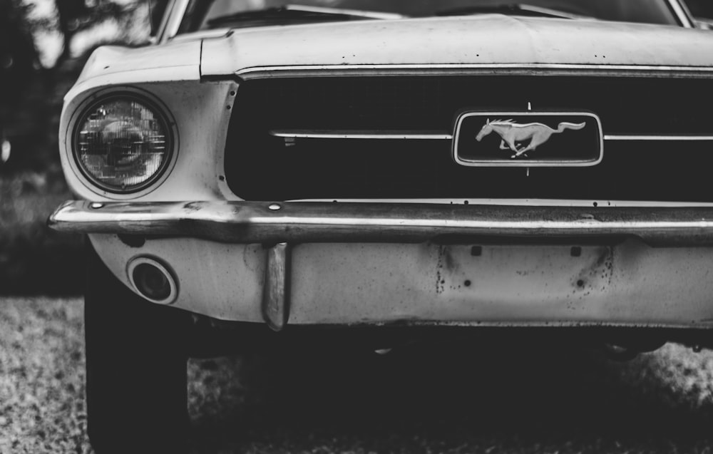 selective focus photography of white Ford Mustang coupe
