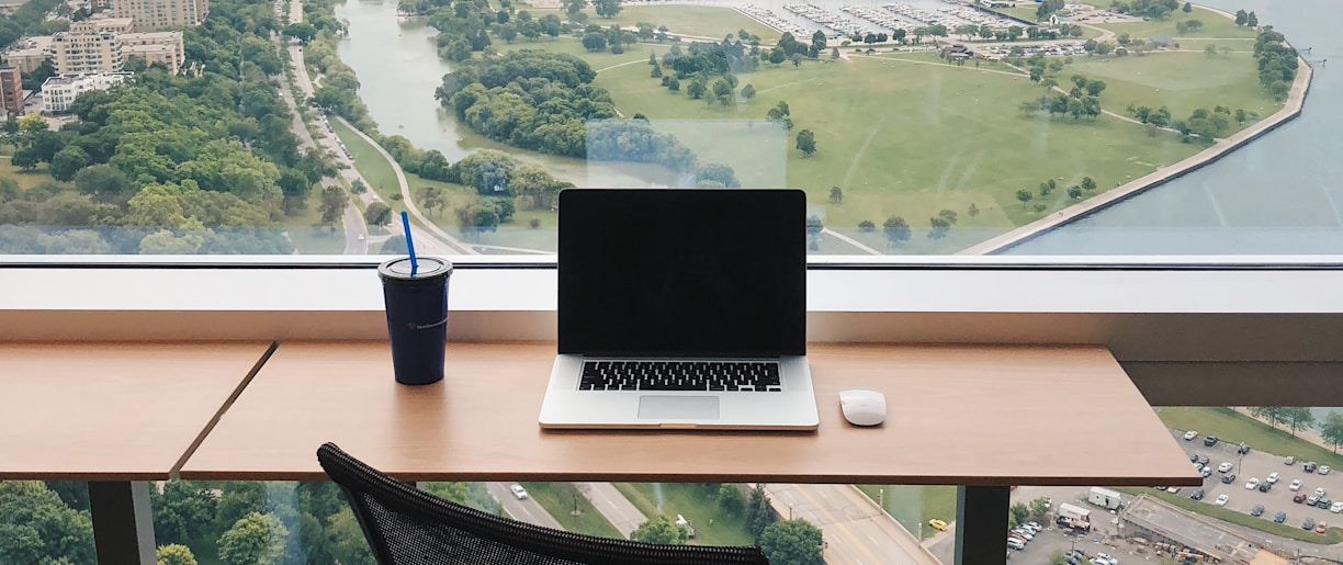 a laptop computer sitting on top of a wooden desk