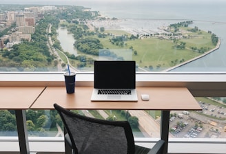 a laptop computer sitting on top of a wooden desk