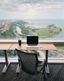 a laptop computer sitting on top of a wooden desk