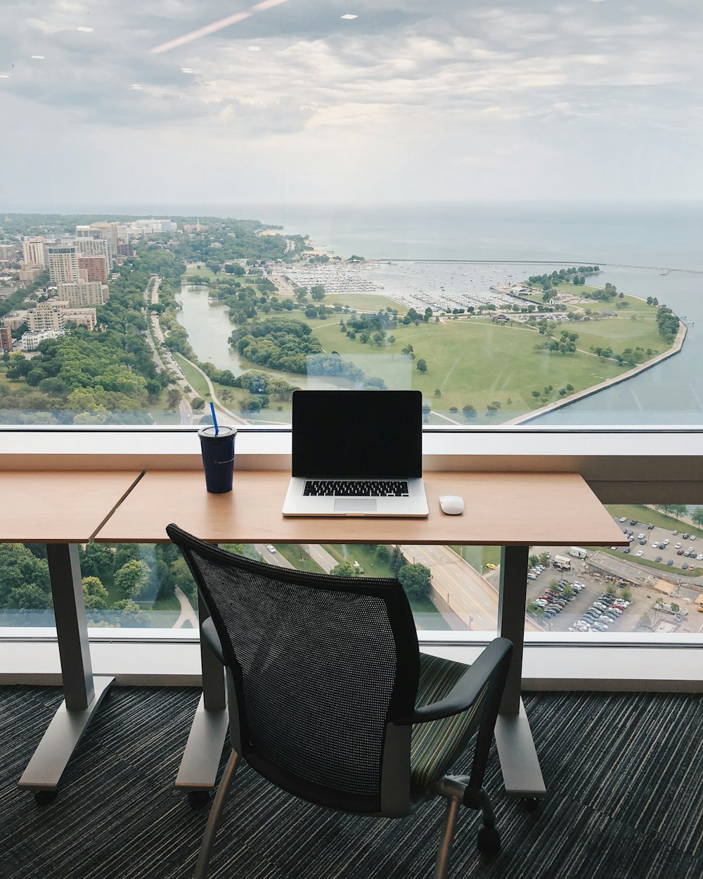 a laptop computer sitting on top of a wooden desk