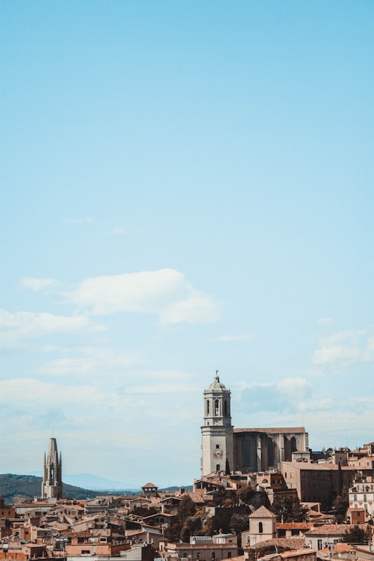 houses and church under blue sky in Girona Spain