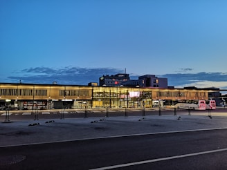 A clean and modern bus from İlGaz Turizm parked in front of a corporate building during sunrise.