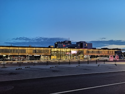 A clean and modern bus from İlGaz Turizm parked in front of a corporate building during sunrise.