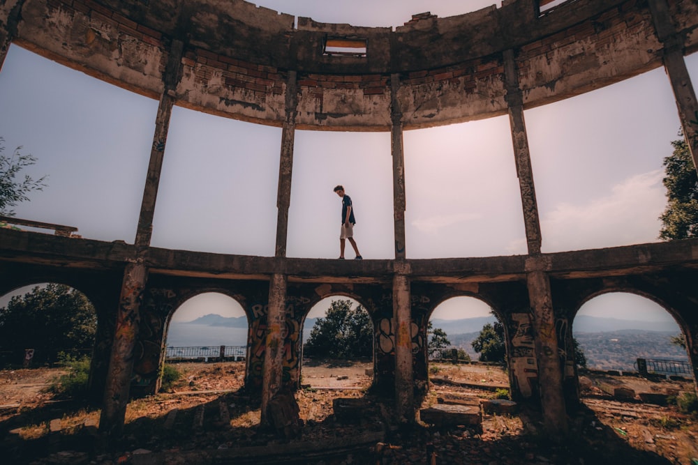 man standing on building at daytime