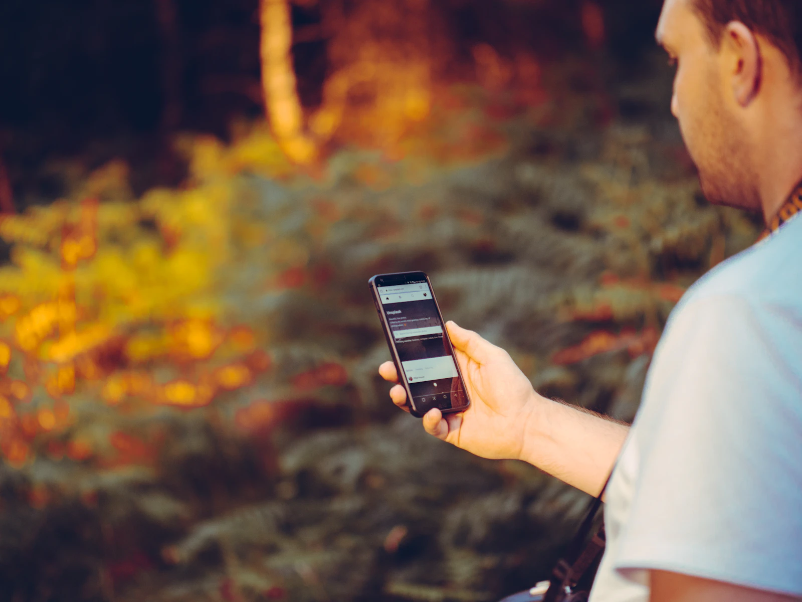 A person holding a smartphone, representing mobile Core Web Vitals field data collected from real visitors
