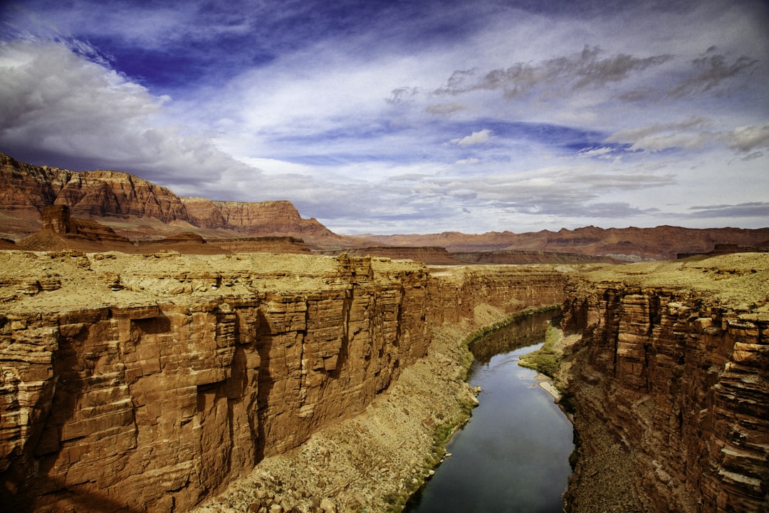 a river running through a canyon surrounded by mountains, From the bridge over Marble Canyon on US 89A we could see the 