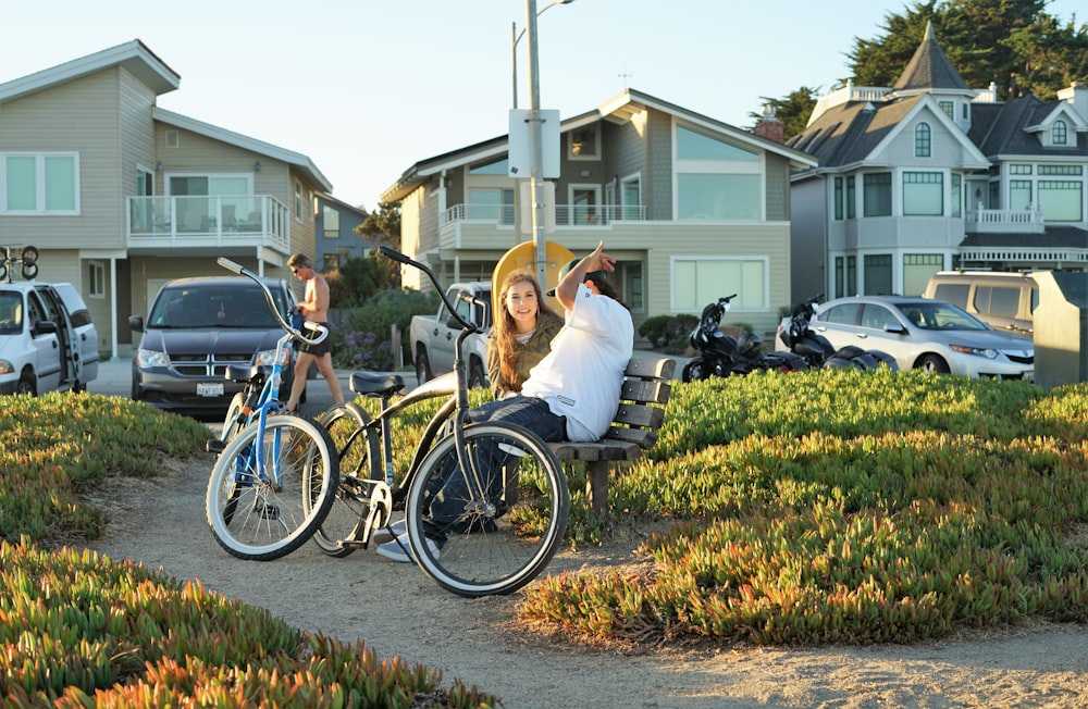 man and woman sitting on bench near bicycles