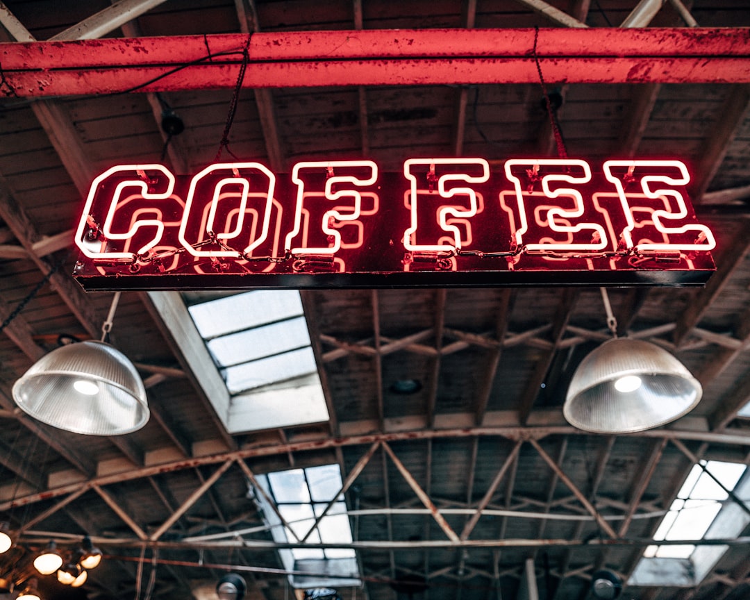 person taking photo of Coffee signage, Love this coffee place in downtown San Diego