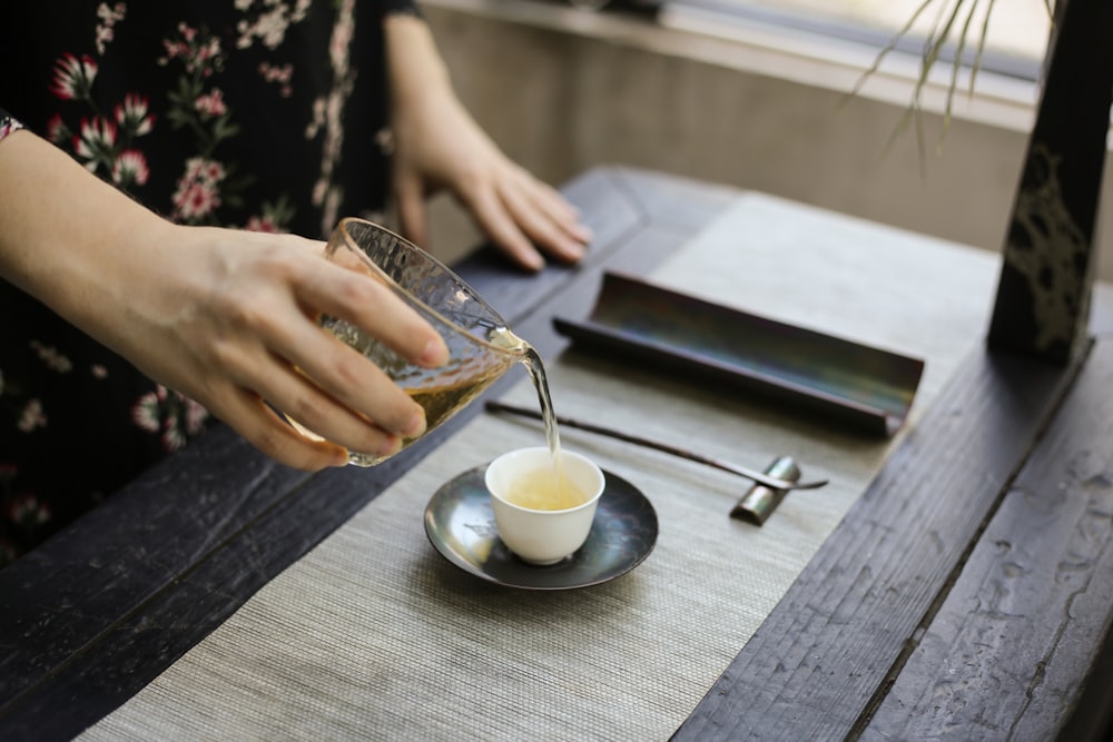 white ceramic teacup on saucer