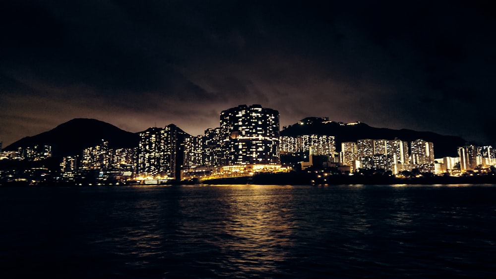 city light buildings beside body of water