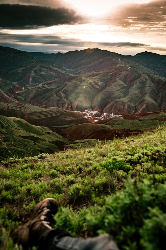 green grass covered mountain range in Xining China