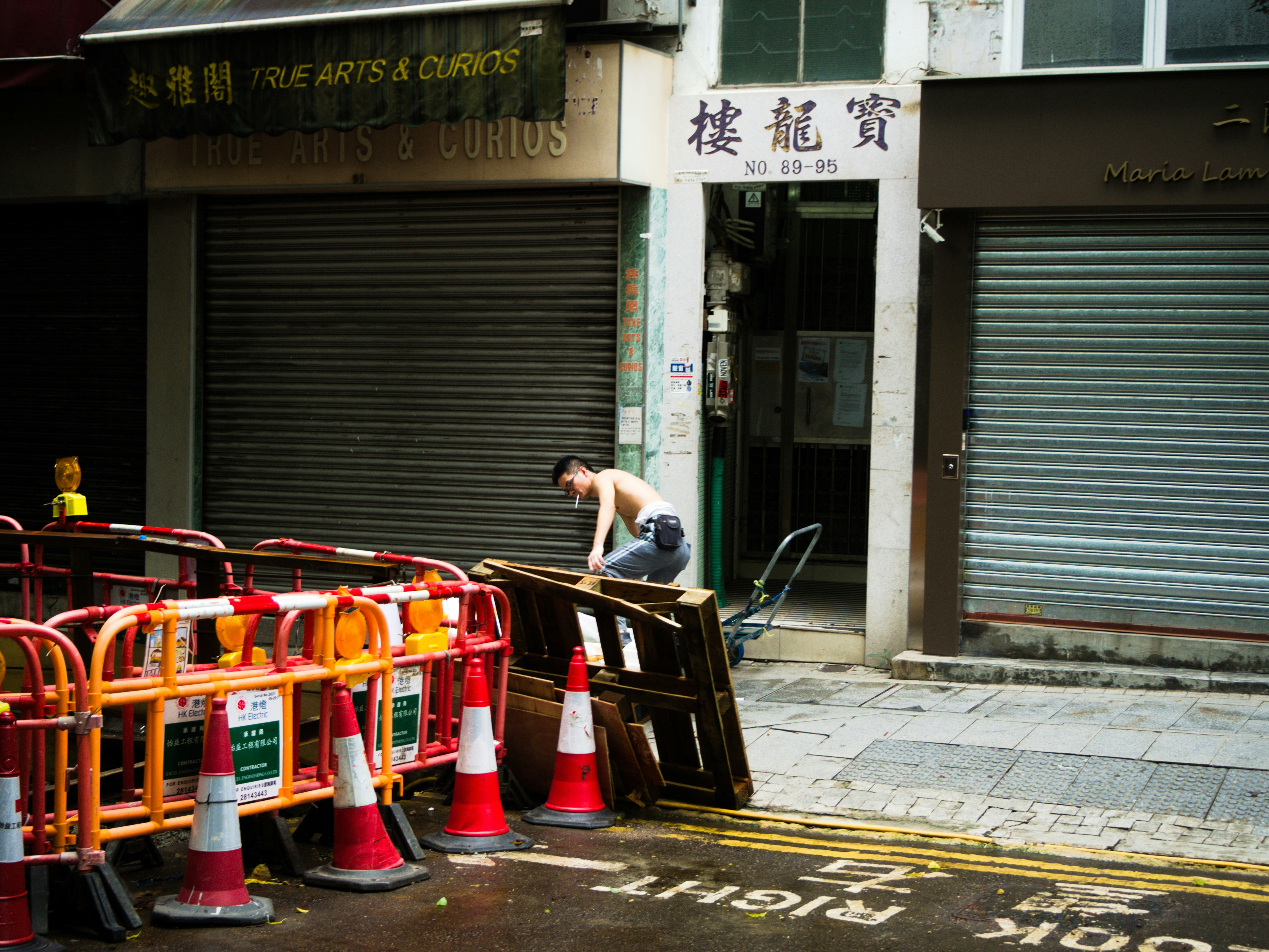 man using blue and gray platform dolly