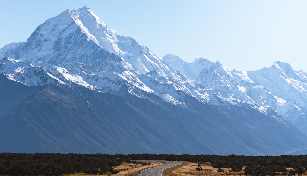 mountains covered with snow near road