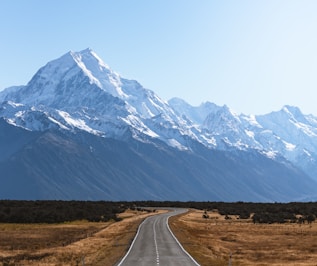 mountains covered with snow near road