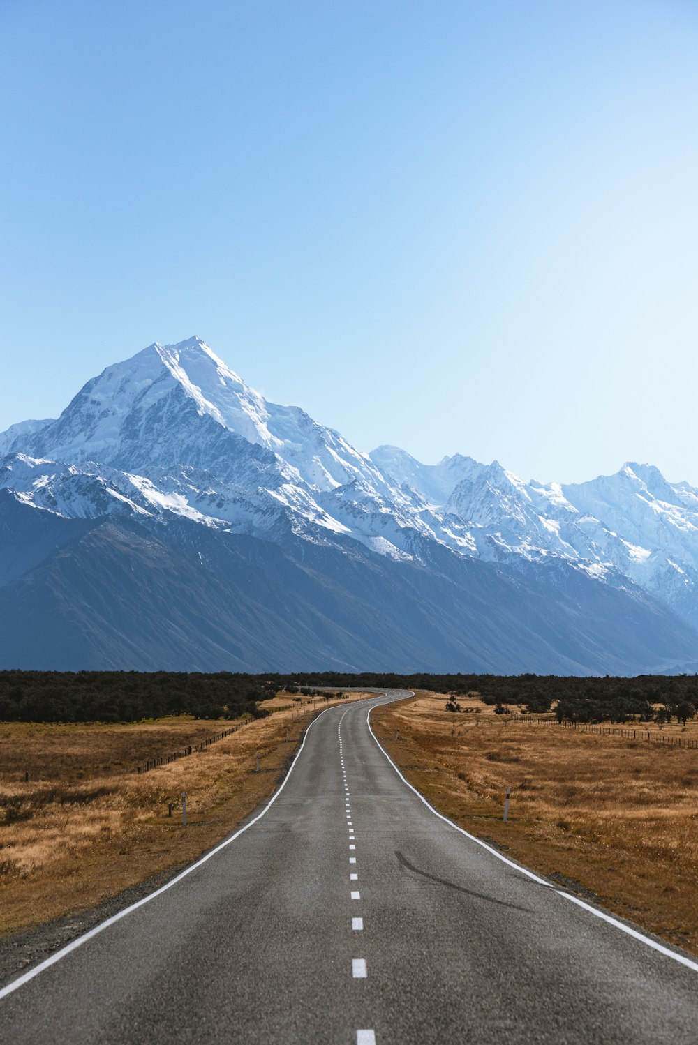 mountains covered with snow near road