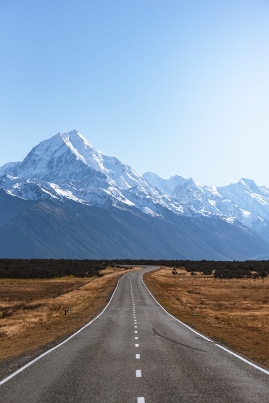 mountains covered with snow near road in Mount Cook New Zealand