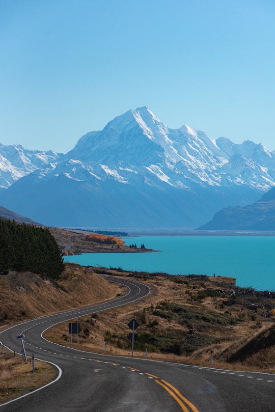 snow covered mountain near body of water during daytime in Lake Pukaki New Zealand