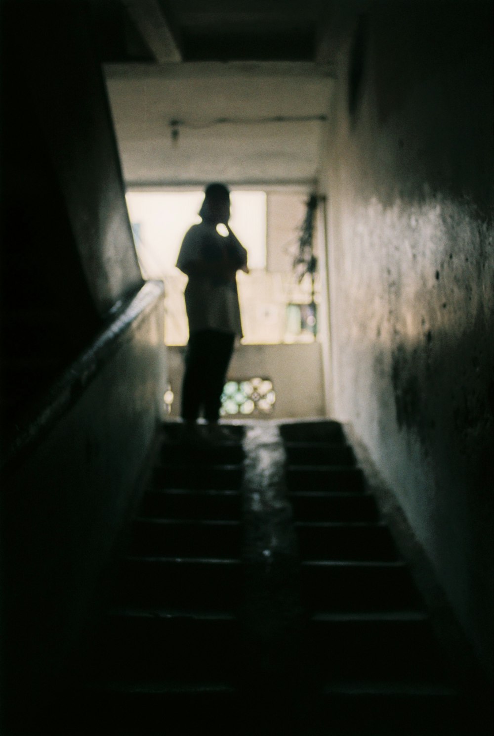 person standing on stairs inside the building