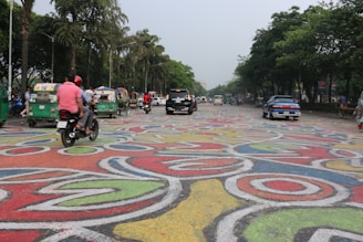 Close-up of vibrant thermoplastic road markings freshly applied on a busy Mumbai street.