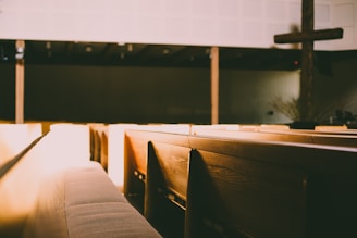 A peaceful church interior with soft lighting and wooden pews.