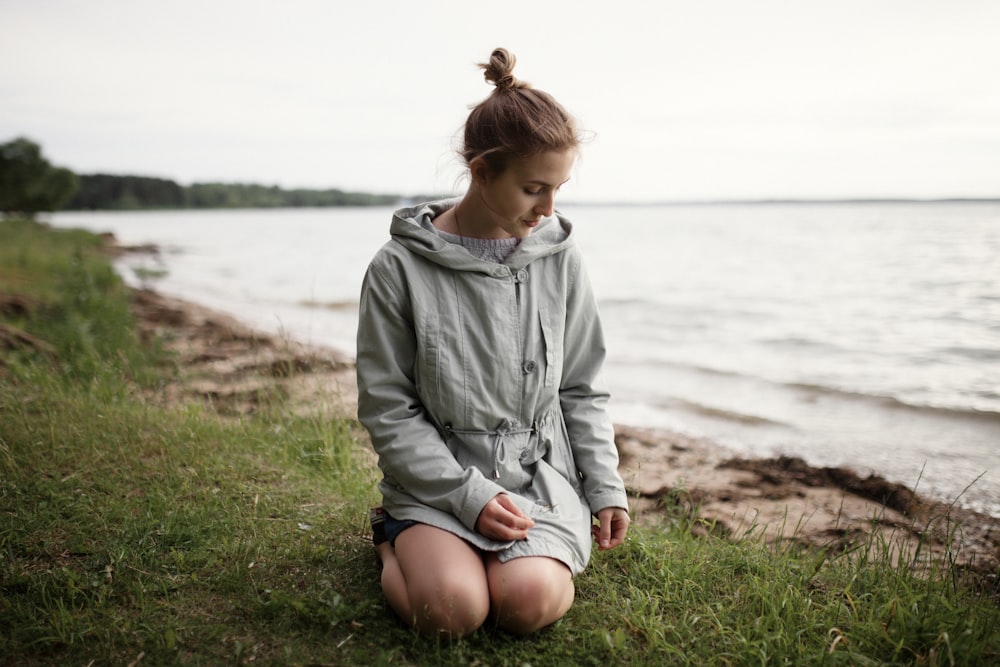 woman beside body of water