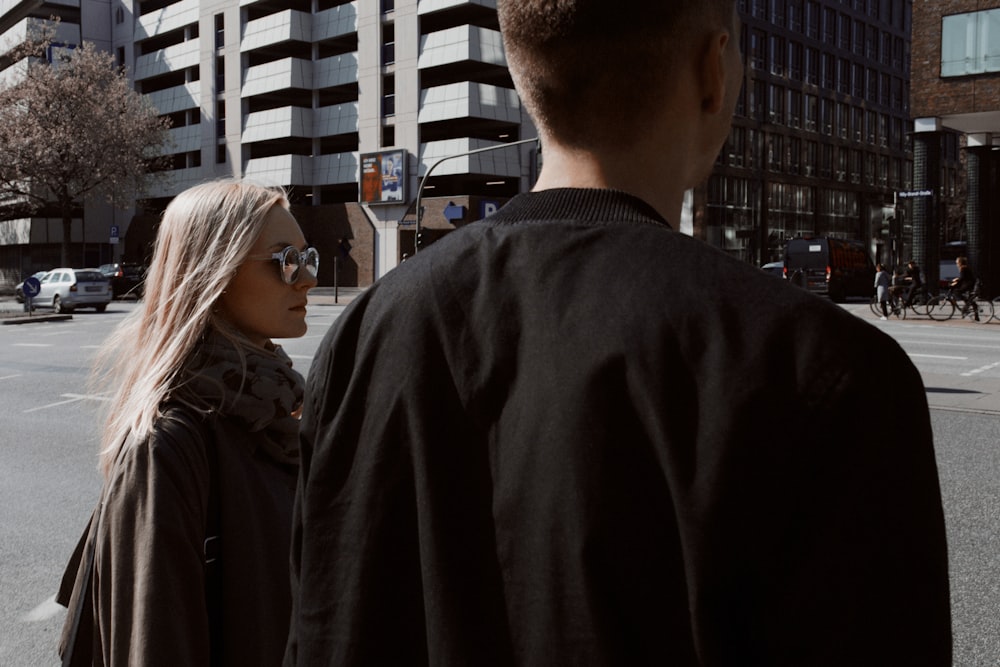 man and woman looking at the street during daytime