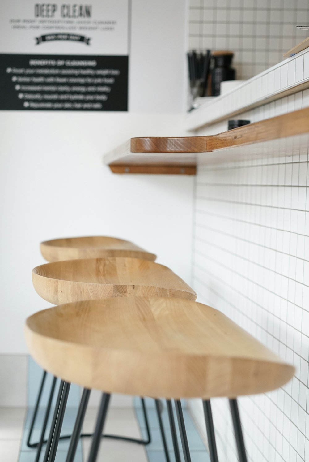 three brown wooden stools beside brown wooden desk