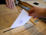 A close-up of hands holding a ballot during an election.