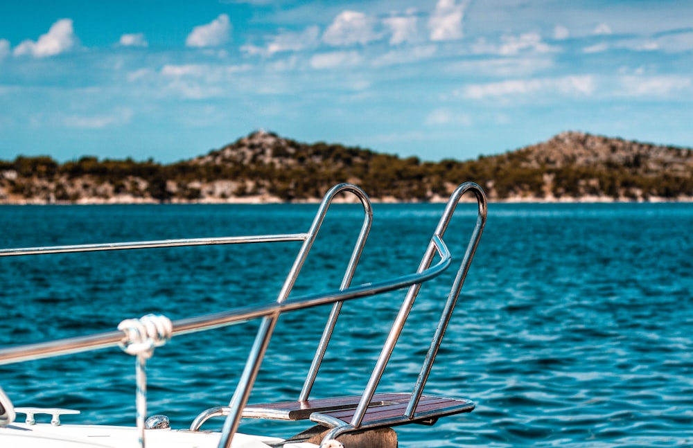 grey rails boat on body of water during daytime