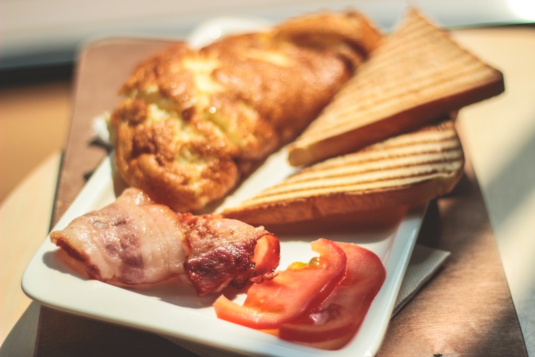 toasted bread and bacon served on white ceramic plate