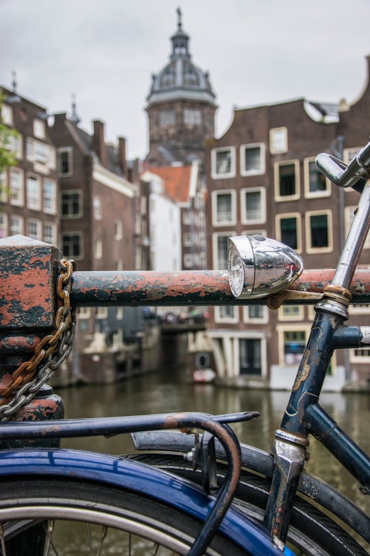 bicycle leaning on rail in Oudezijds Voorburgwal Netherlands