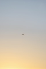 An animated plane ascending against a gradient sky transitioning from day to sunset.