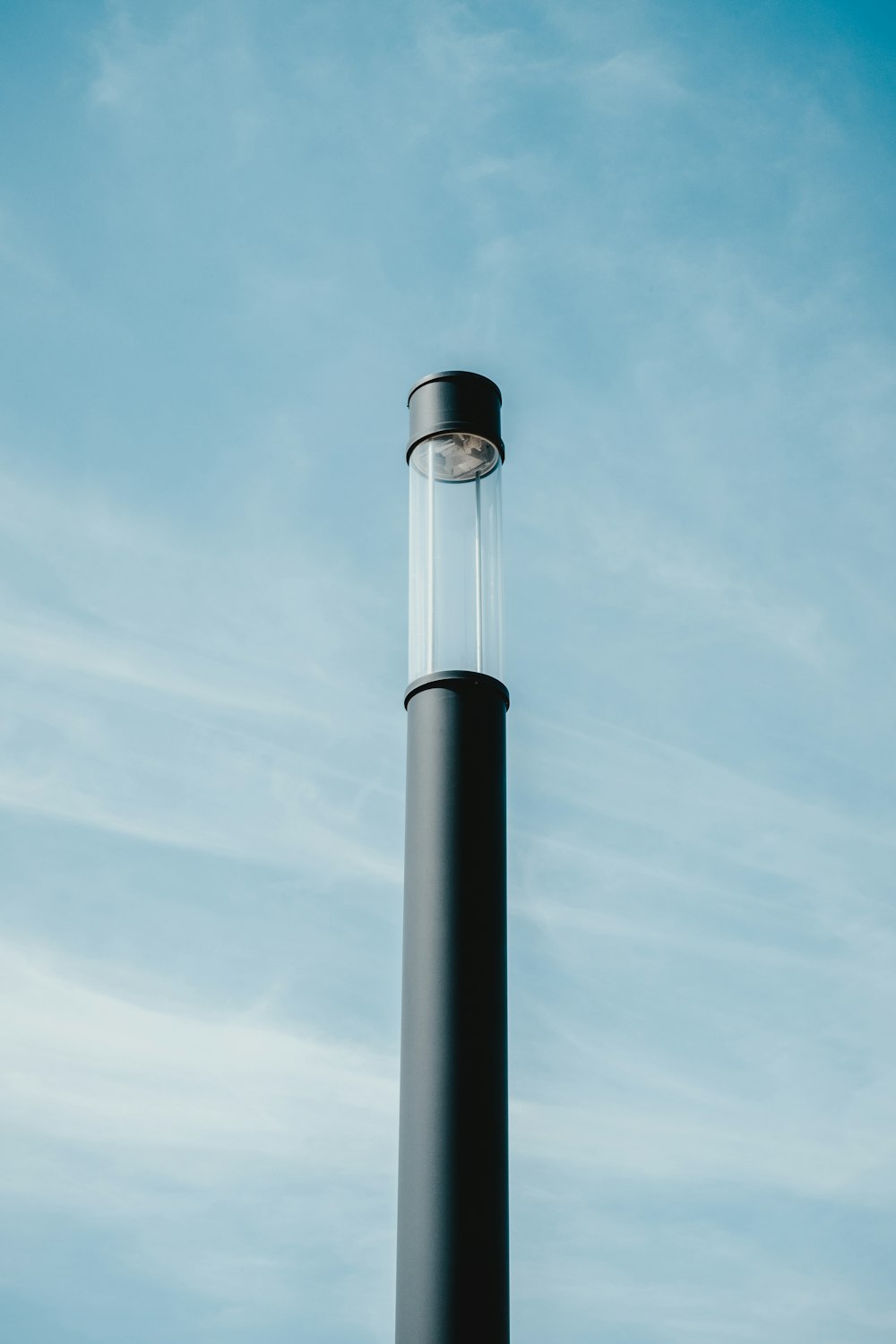 cylindrical black device under cloudy sky