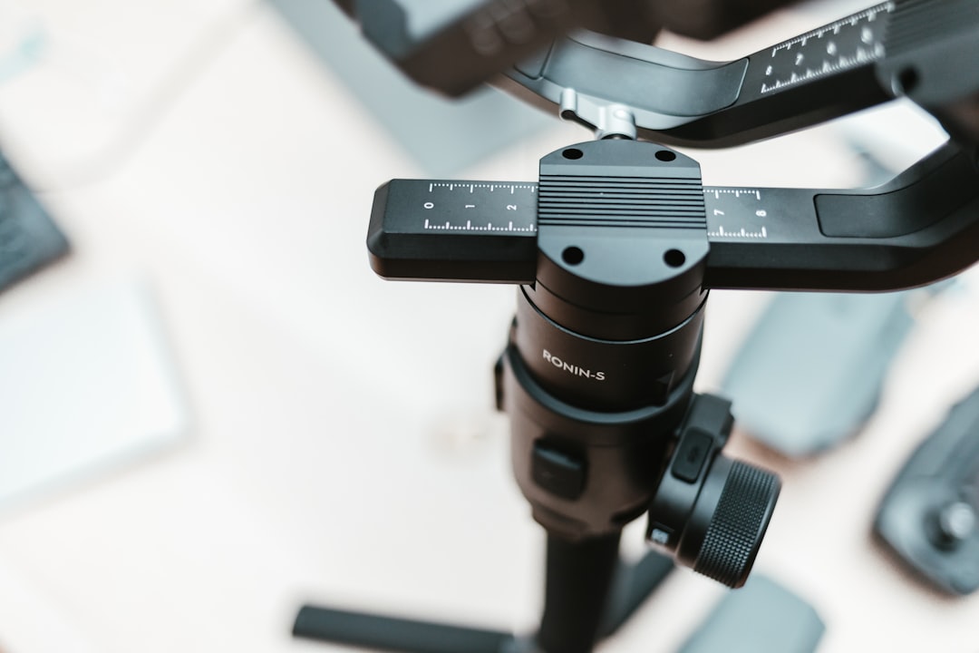 black camera stabilizer, DJI Ronin-s on my desk