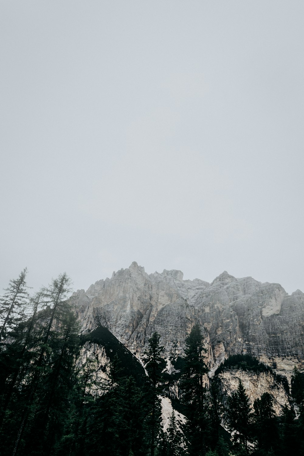 snow covered mountain with fog