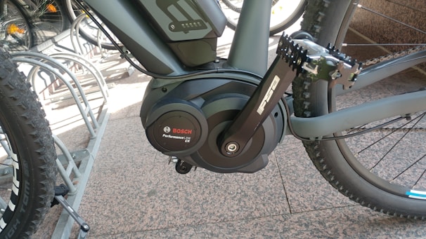 Close-up of a Bafang mid-motor being installed on a KTM bicycle frame in a workshop.