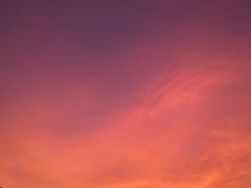 Vibrant sky painted with shades of pink, orange, and purple, creating a serene and captivating atmosphere with soft gradients and smooth transitions.
