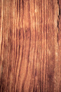 Close-up of finely crafted wooden paneling with natural grain patterns in a modern interior.