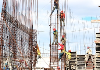 people working on building during daytime