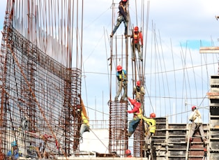 people working on building during daytime