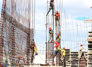 people working on building during daytime