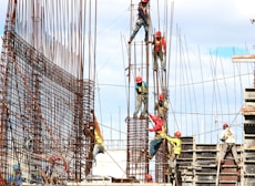 people working on building during daytime