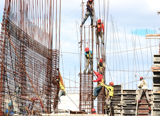 people working on building during daytime