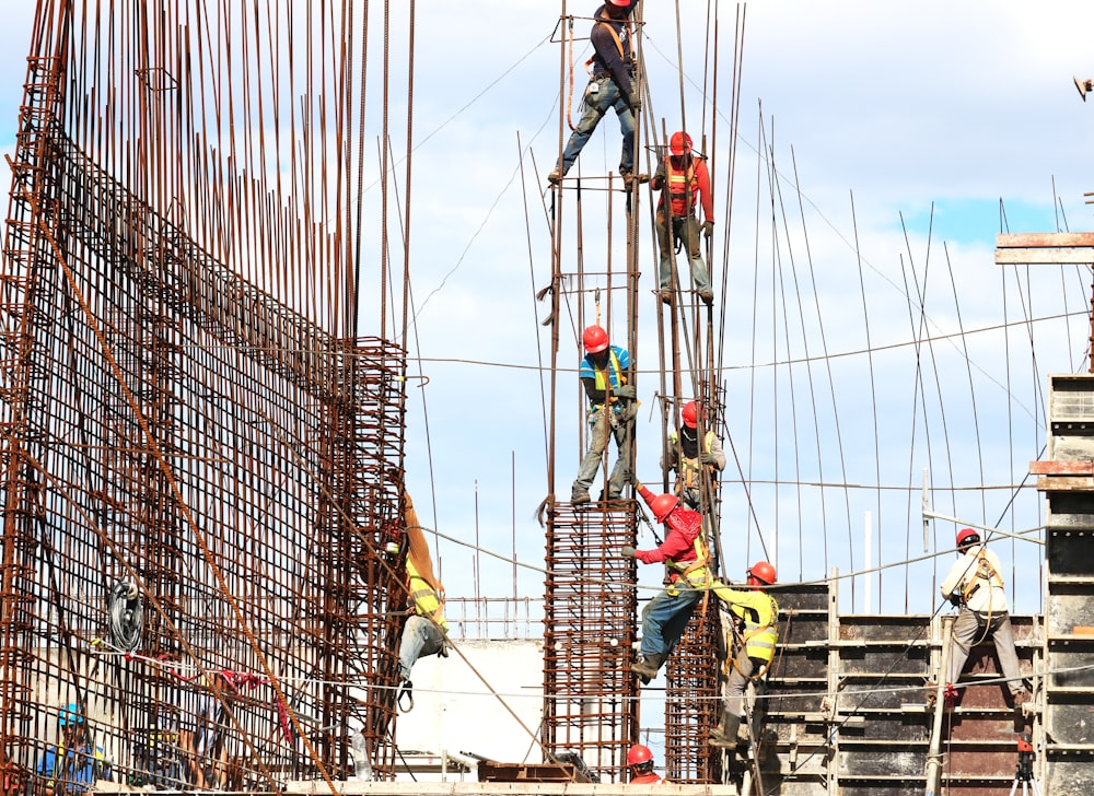 people working on building during daytime